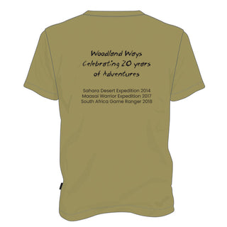 Olive Green T shirt with the Woodland Ways Logo embelished with a 20th anniversary design, showing the back of the shirt with a list of international expedition examples. 