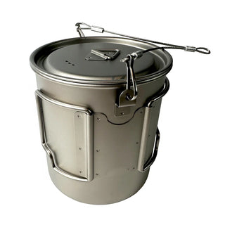 Image shows  the titanium camping cup with folded butterfly handles, and wire bail arm.