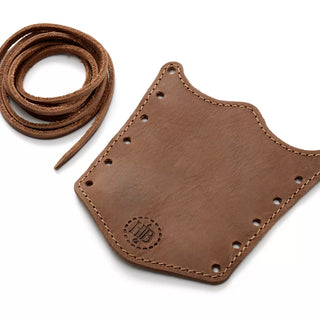 Hults Bruk brown leather overstrike guard (regular size) featuring complimenting stiches, a stamped HB logo, and leather cord to tie the guard onto your axe handle. 