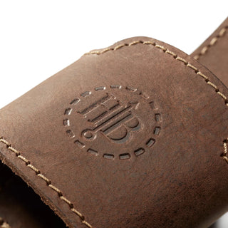 A Hults Bruk Brown leather axe holster or loop, worn on the belt to carry an axe. Shown here with a stamped HB logo, and complimenting stiching. 