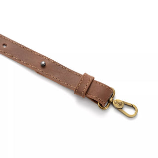 Hults Bruk Leather Axe Sling - a brown leather sling with brass fittings featuring a stamped HB logo