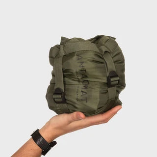 Snugpak Antarctic Mat - a green sleeping mat shown here in a compression sack.