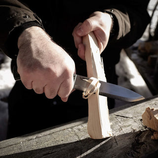 Casstrom No.14 Swedish Forest Knife with a green Micarta handle, carving a feather stick with ease.