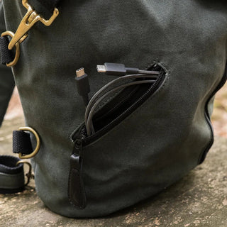 The DD Crosswind Sling bag, shown here with a small zipped pocket for storing useful items such as this charging cable.