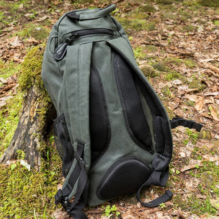 Image shows a Quest Rucksack, with it's padded back panel, mesh side pouch for a water bottle, and the zipped pocket at the top.