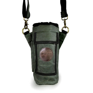 A green waxed canvas water bottle pouch, with extra pockets for other items, featuring a shoulder strap.