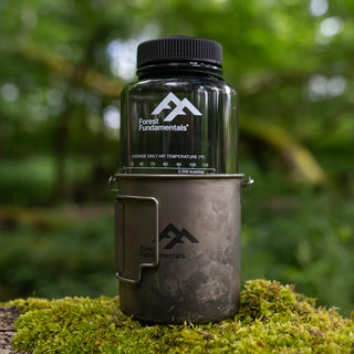 The Forest Fundamentals Titanium camping cup with Nalgene bottle nested inside.