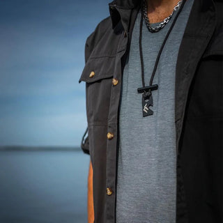Forest Fundamentals Sidekick firelighting necklace. A hardened steel striker, a ferrocerium rod, and some survival paracord. Shown here worn around the neck
