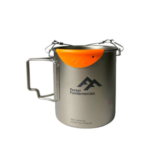 The Titanium camping cup with butterfly handles, wire bail arm and an orange silicone lip protector. 