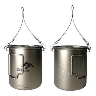 Image shows a pair of titanium camping cups, with wire bail handles, the Forest Fundamentals Logo, and stamped internal volume markings